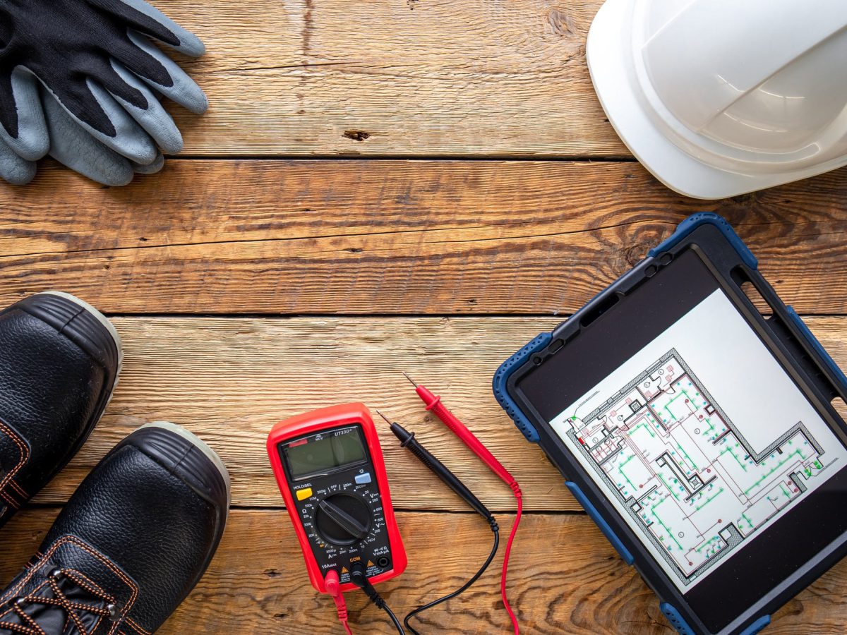 Flat lay composition with electrician's tools and accessories.